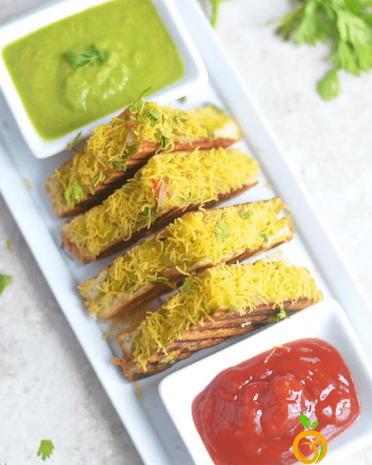 Indian-style sandwiches with sauce on a white board.