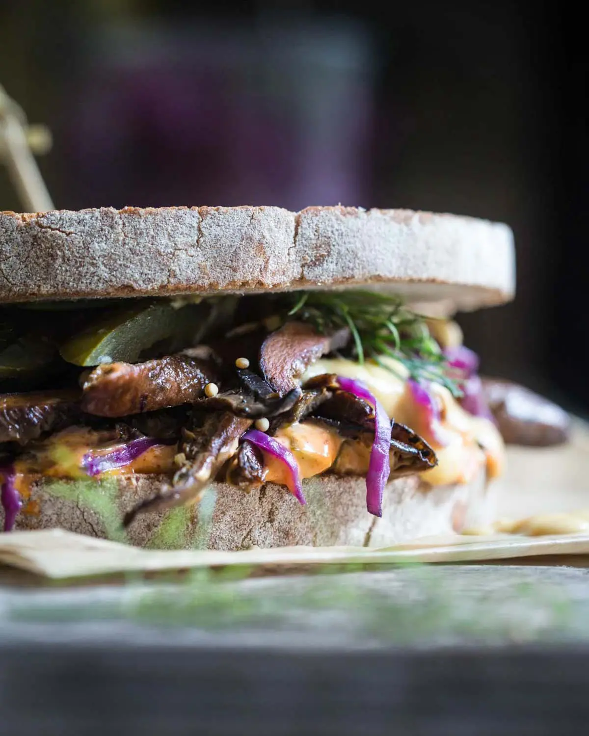 A vegan Mushroom Reuben Sandwich on paper.