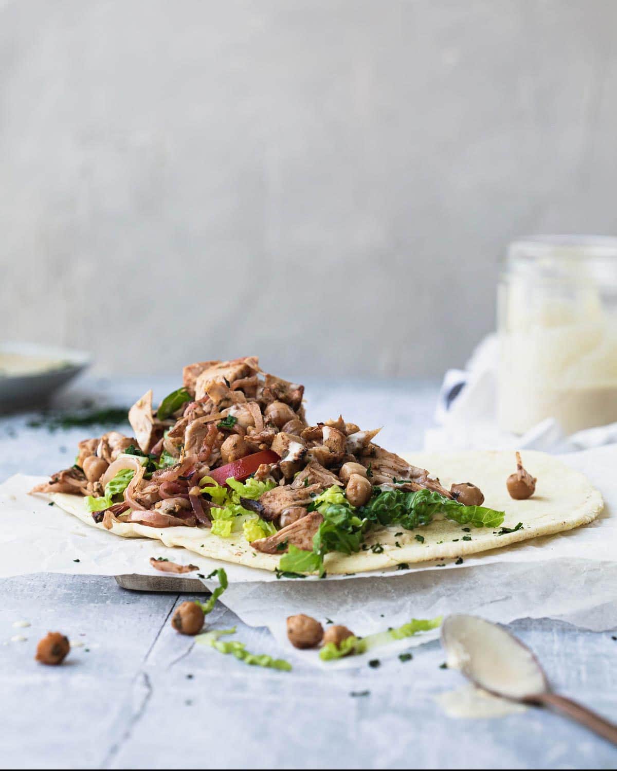 A pita topped with vegan meat and chickpeas.