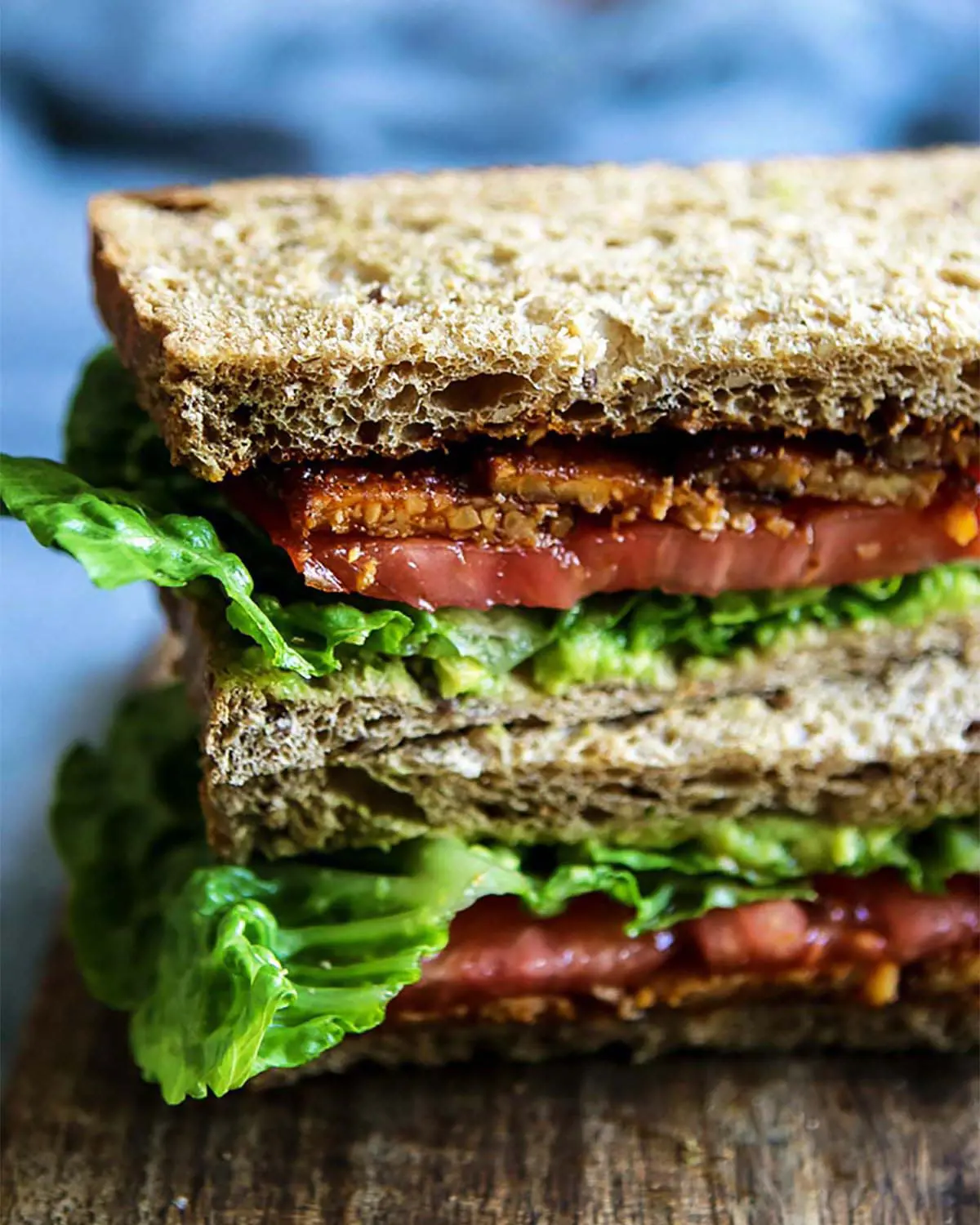 A vegan BLT on a wooden board.