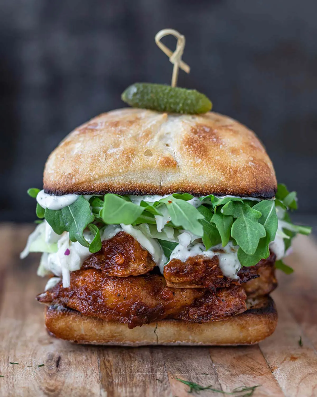 A stacked vegetable burger on a wooden board.