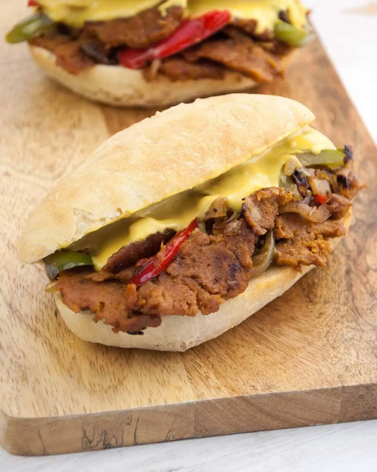 A vegan meat sub on a wooden board.