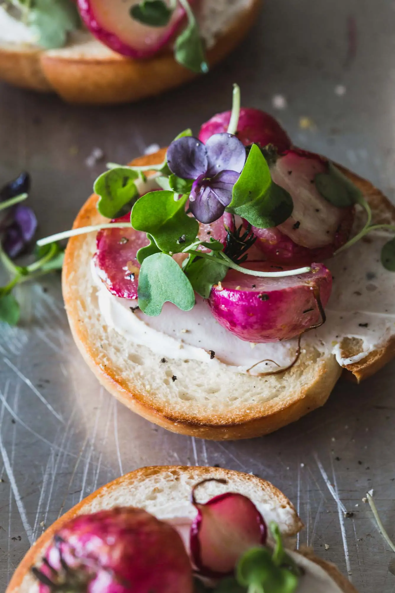 Radishes on a mini bagel with micro greens.