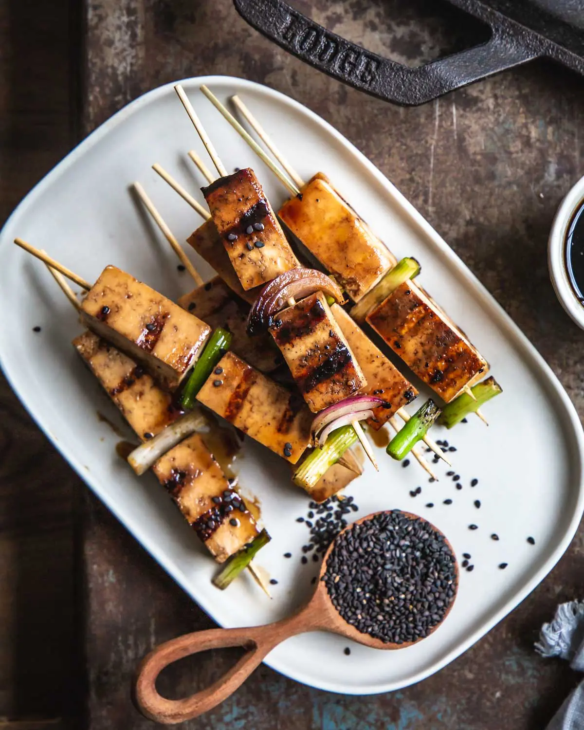 Tofu on skewers with sesame seeds. 