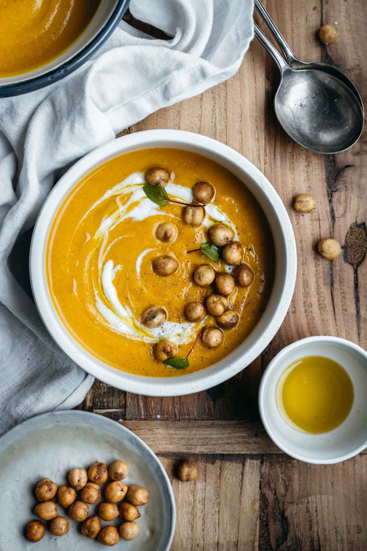 Bowls of pumpkin soup with crispy chickpea croutons.