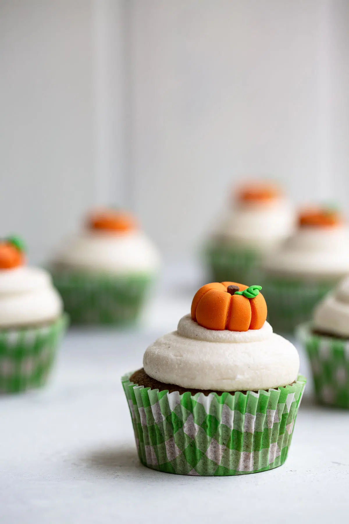Pumpkin cupcakes with pumpkin toppers.