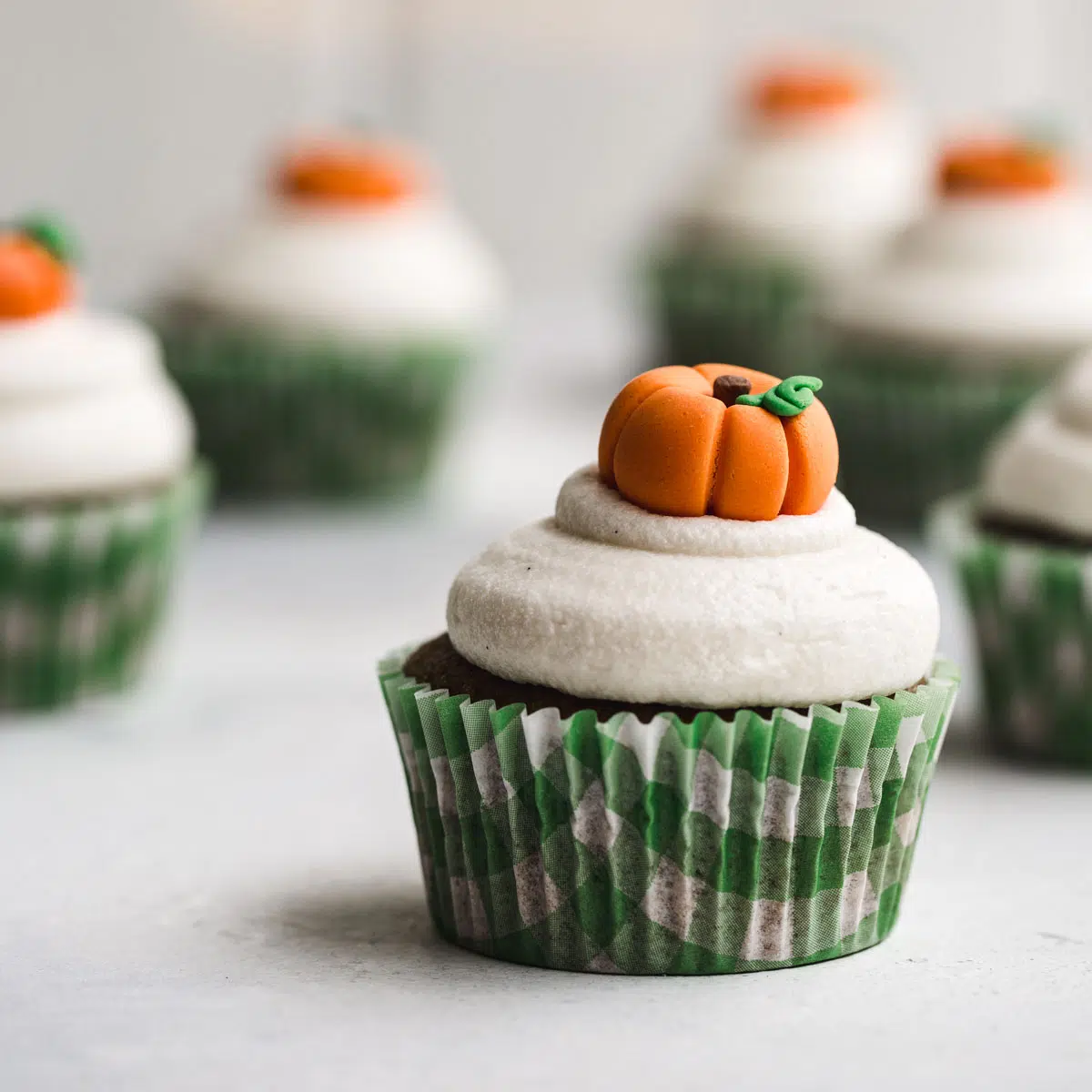 A cupcake with a pumpkin topper.