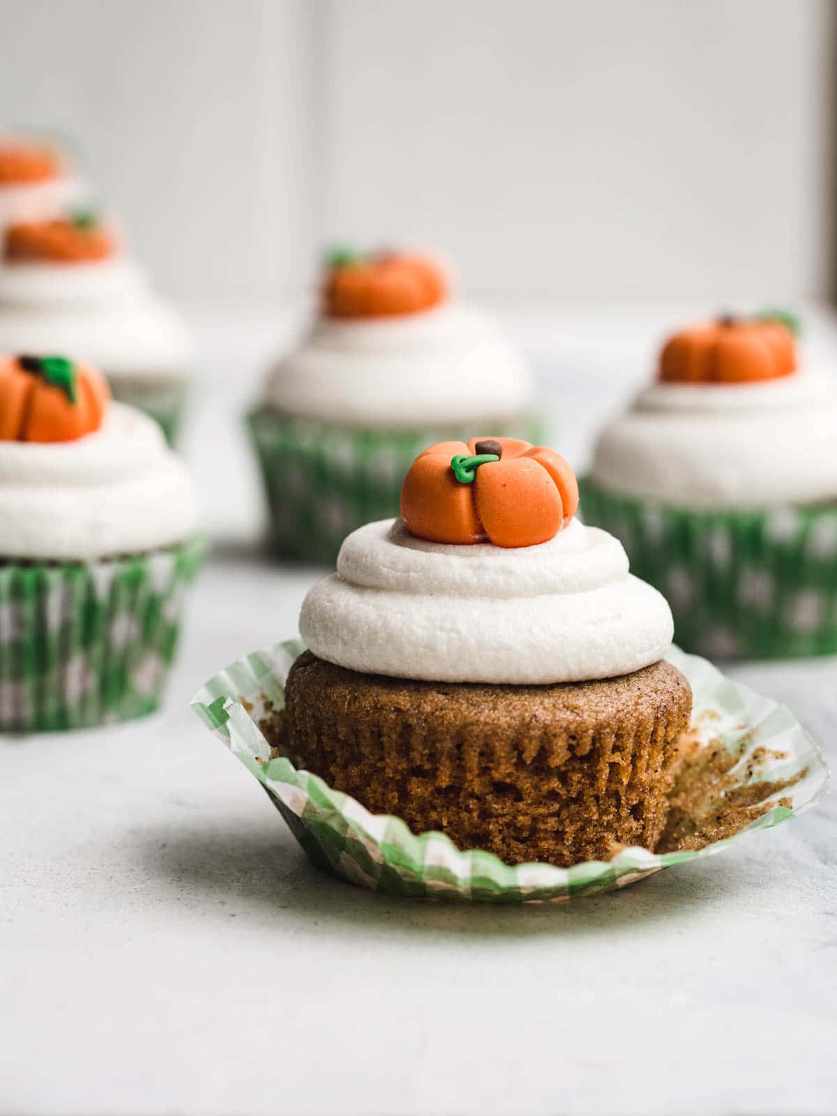 A cupcake with a pumpkin topper.