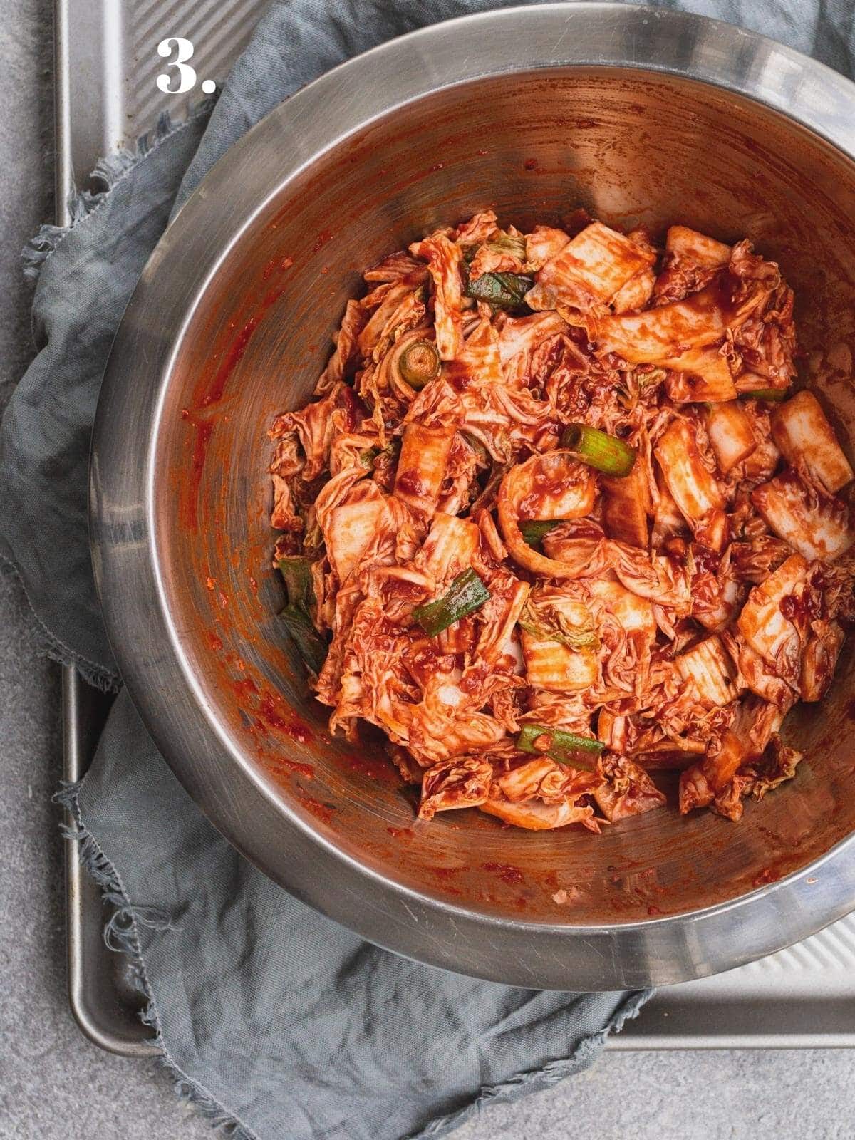 Cabbage and kimchi paste combined in a bowl. 