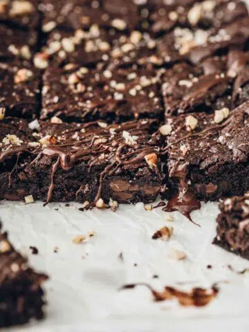 Gooey chocolate brownies on baking paper.