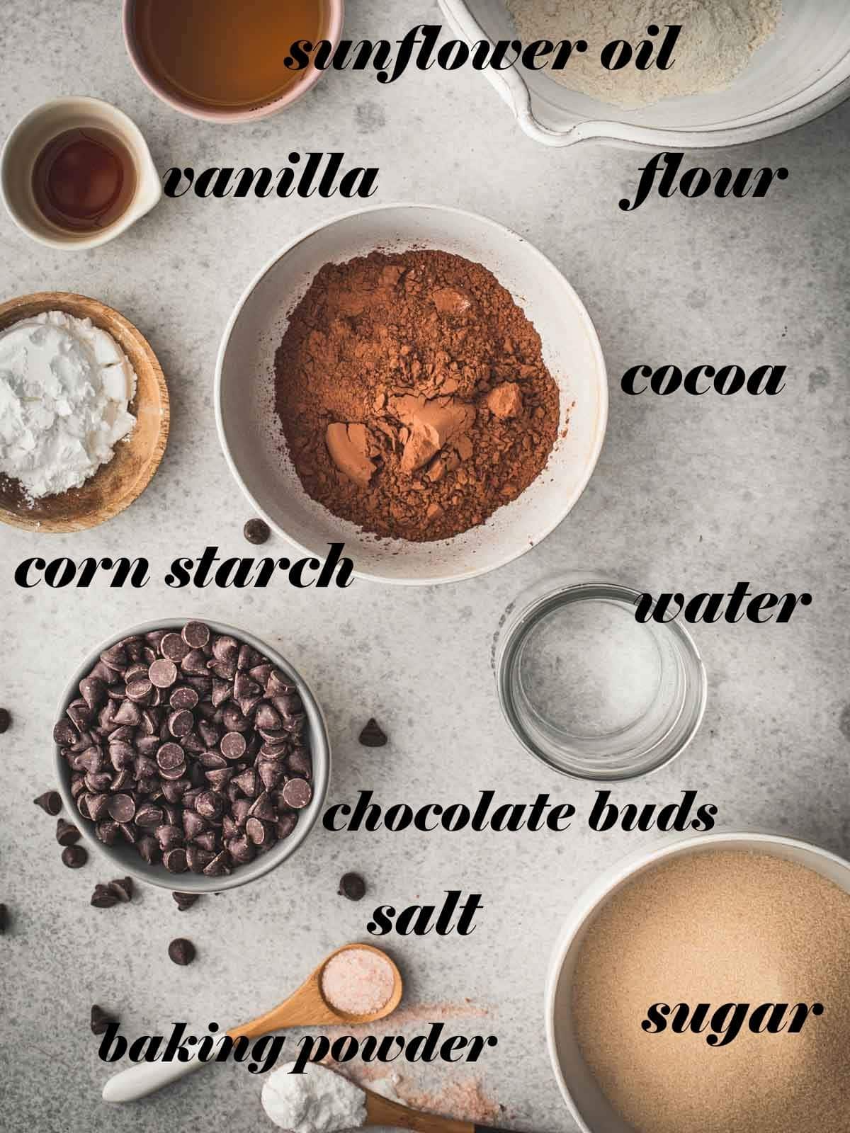 Brownie ingredients in bowls on a grey background.