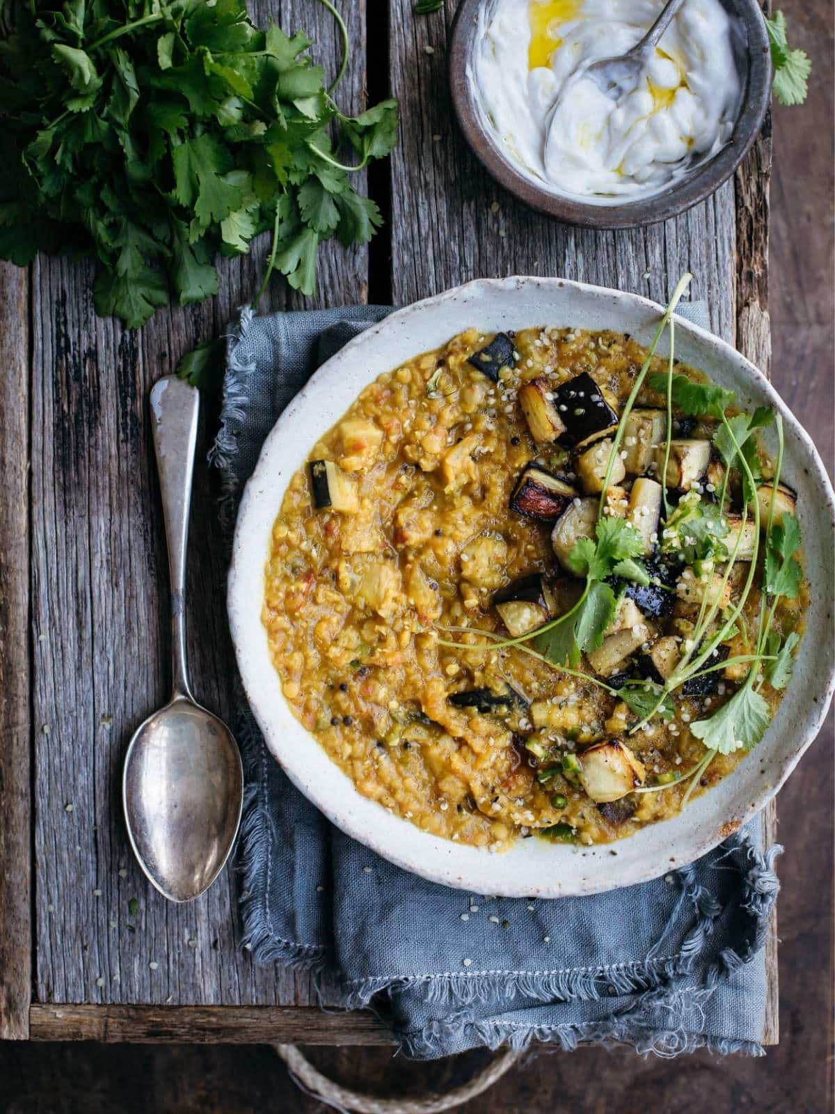 Eggplant dal in a bowl with herbs.