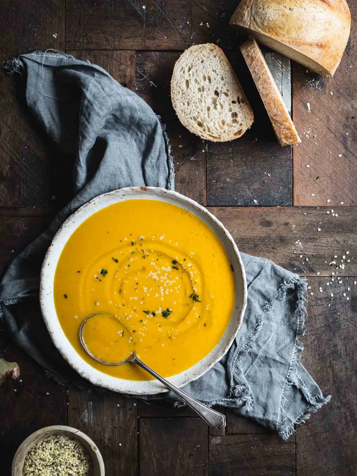 Pumpkin soup in a bowl with bread.