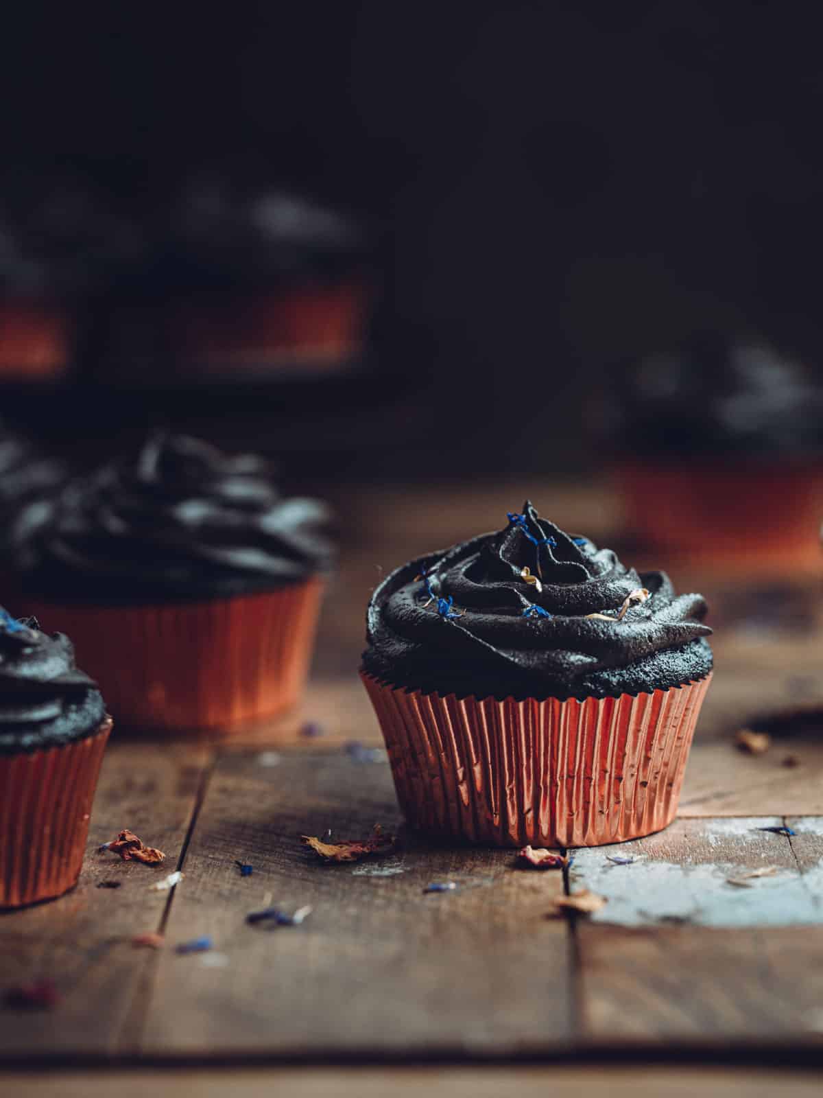 Black cupcakes in copper cake liners.