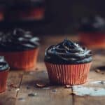 Black cupcakes with black frosting and sprinkles.