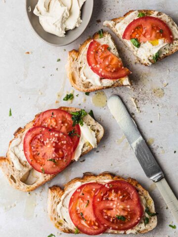 Ricotta and tomatoes on toast slices.