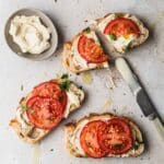 Cashew ricotta in a dish with toast and tomatoes.