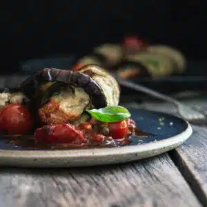 Stuffed eggplant roll on a plate.