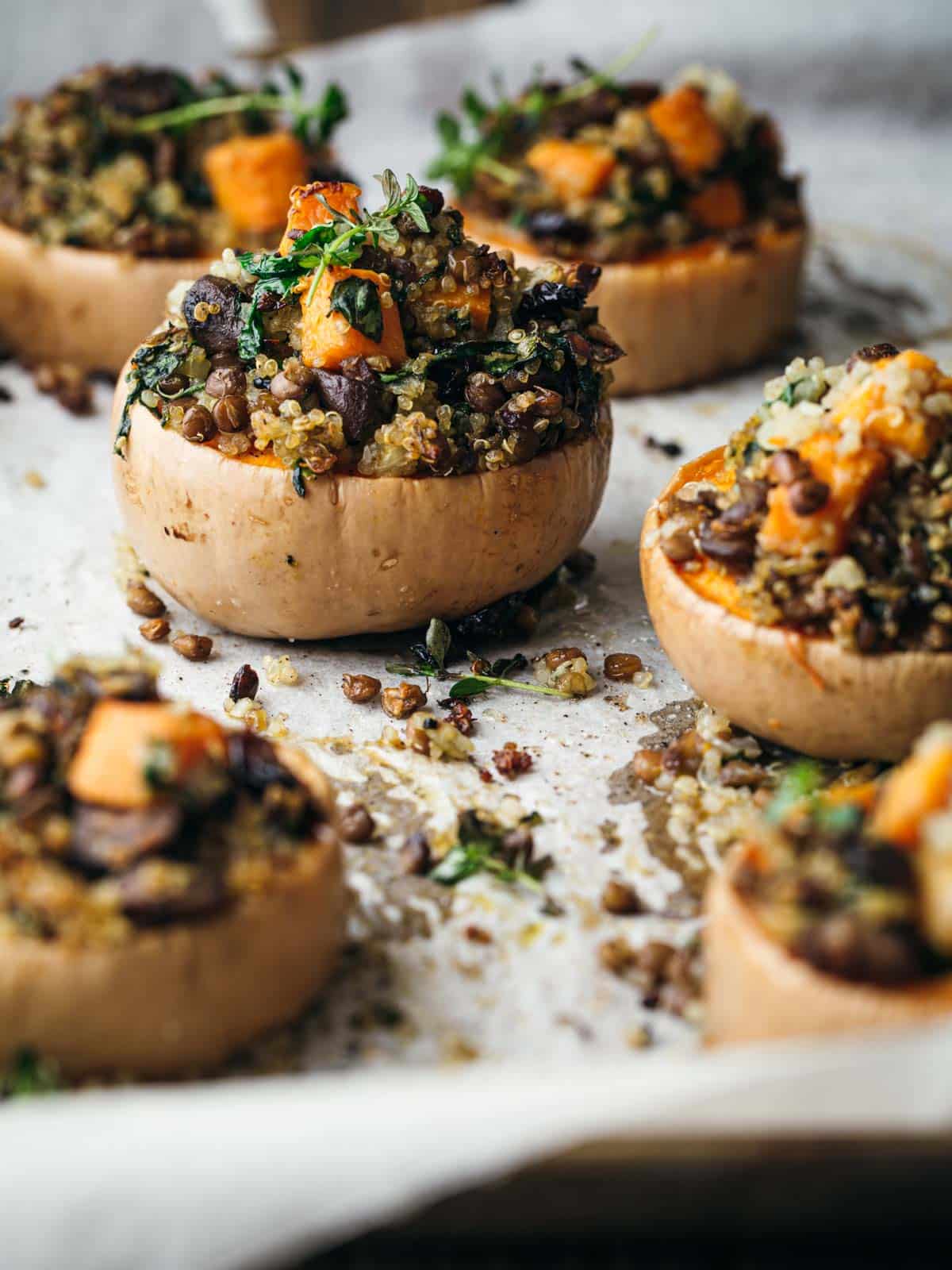 A roasting tray with stuffed butternut squash.
