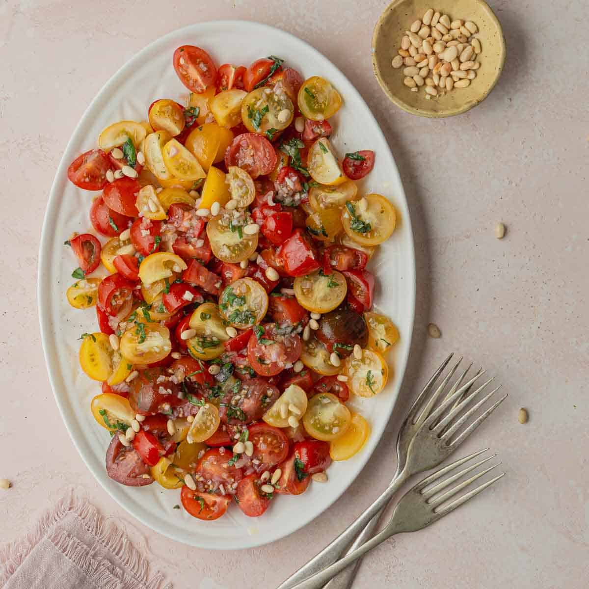 A serving plate with tomato and onion salad. 