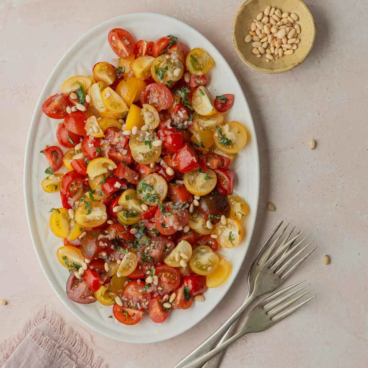 A serving plate with tomato and onion salad.