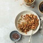 A bowl of granola on a breakfast table.