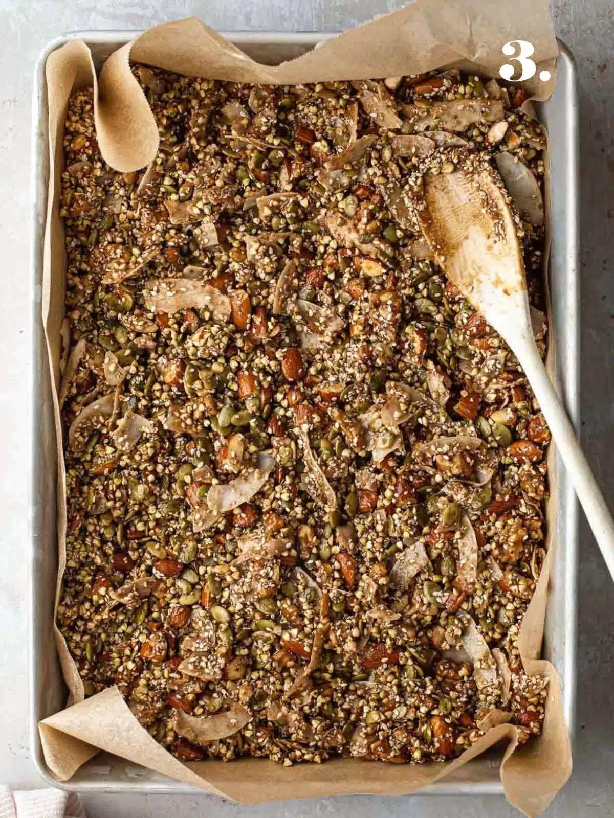 A close-up image of granola in a tray before baking.
