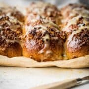 Fresh baked sweet buns with nuts and drizzle.