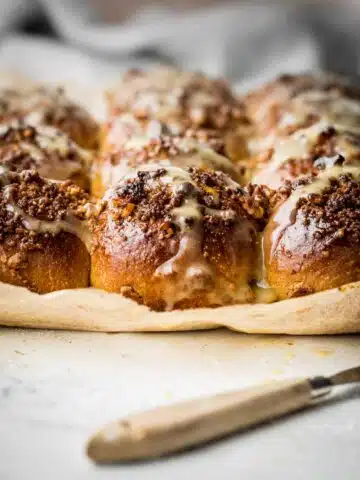 Fresh baked sweet buns with nuts and drizzle.