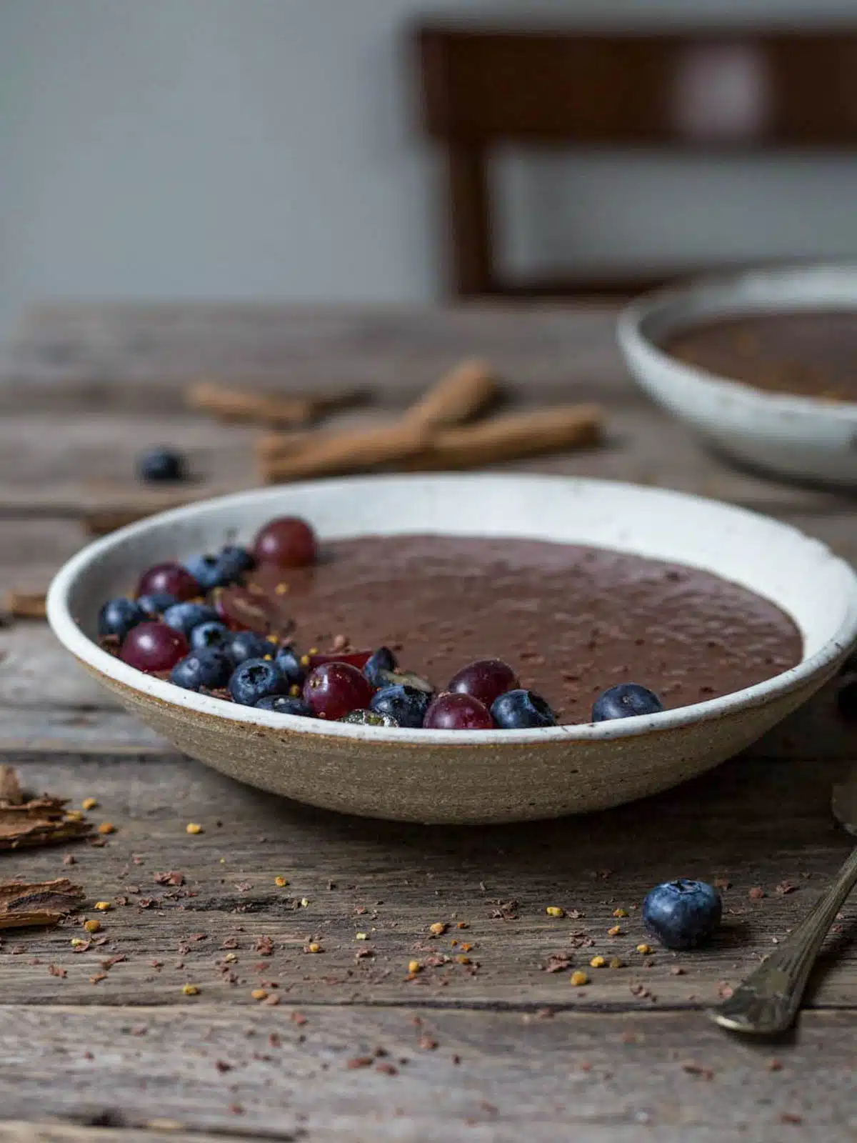 Bowls of chocolate pudding on a wooden table.