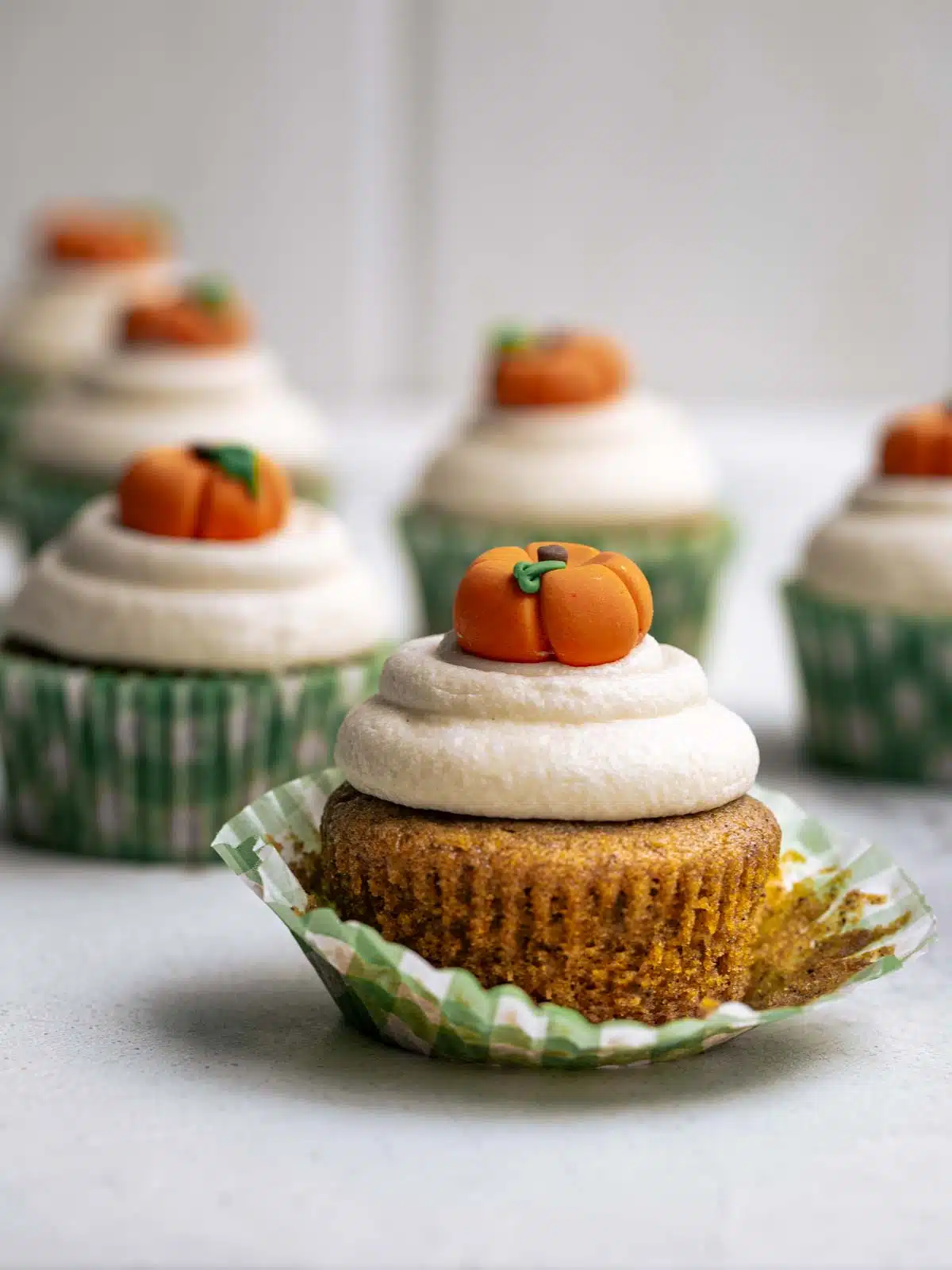 A pumpkin cupcake with the cake part revealed.