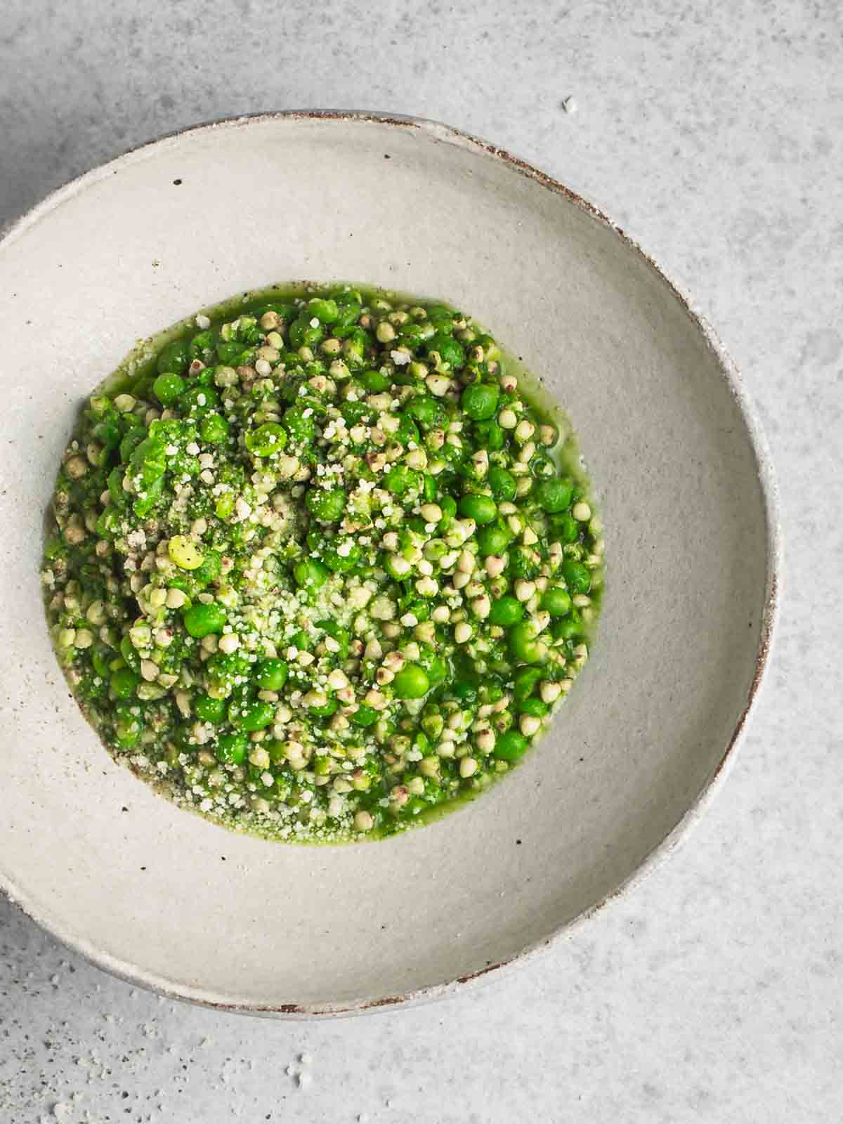 Green pea risotto in a bowl close up.