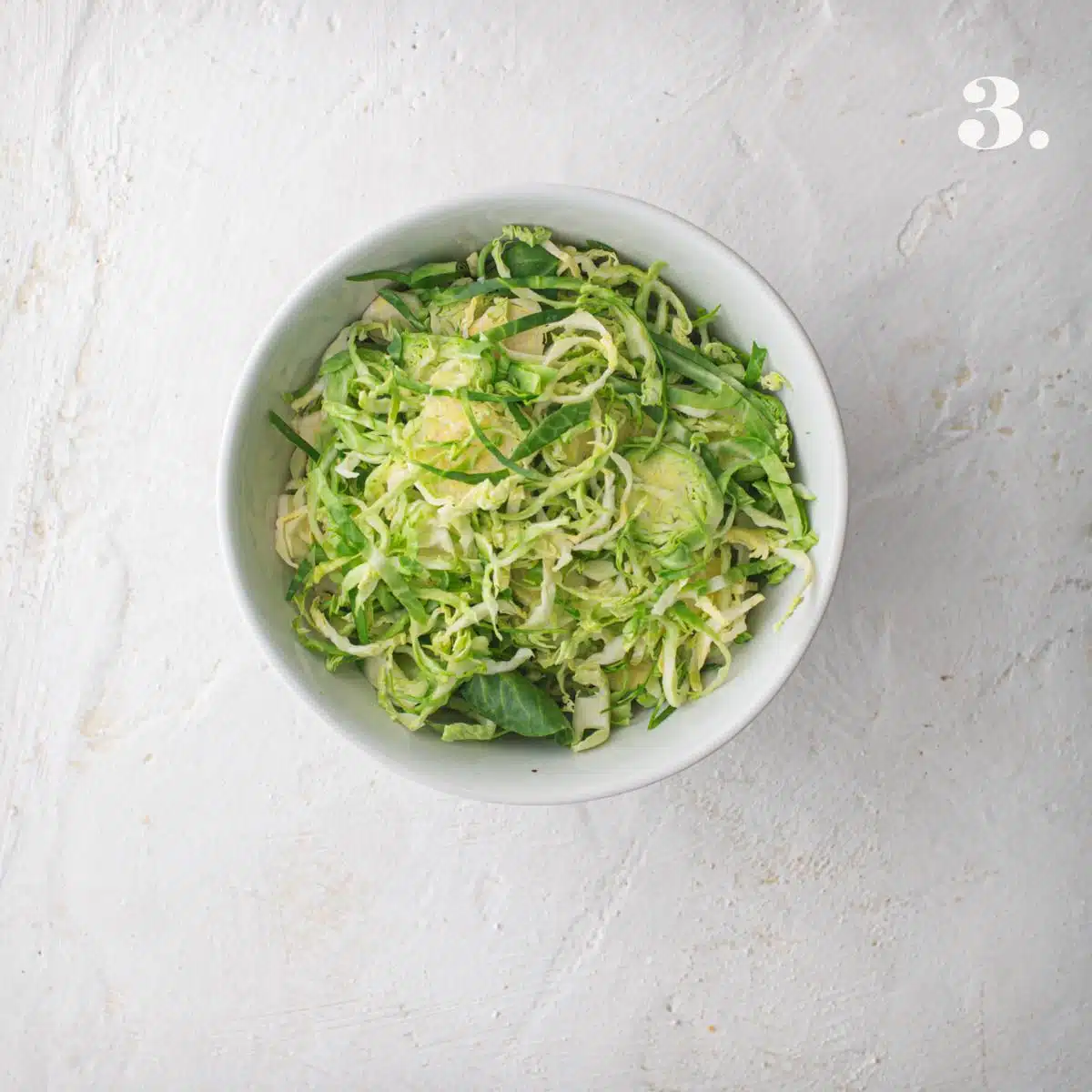 A bowl of shredded Brussels sprouts.