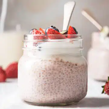 A jar of chia pudding with strawberries.