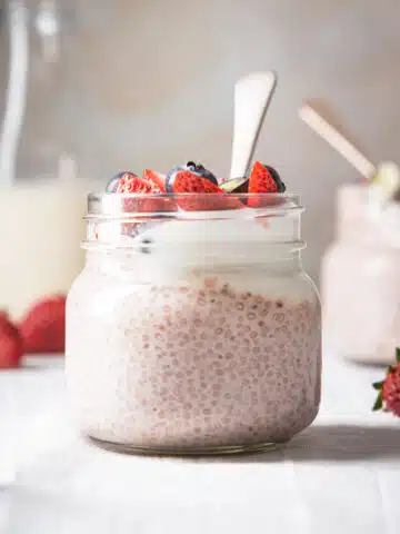 A jar of chia pudding with strawberries.