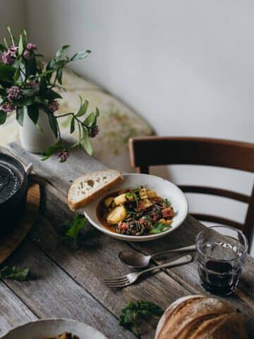 A table setting with a bowl of stew.