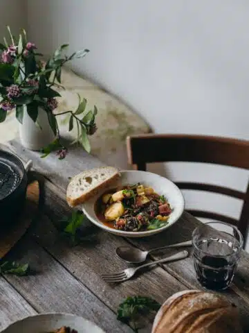 A table setting with a bowl of stew.