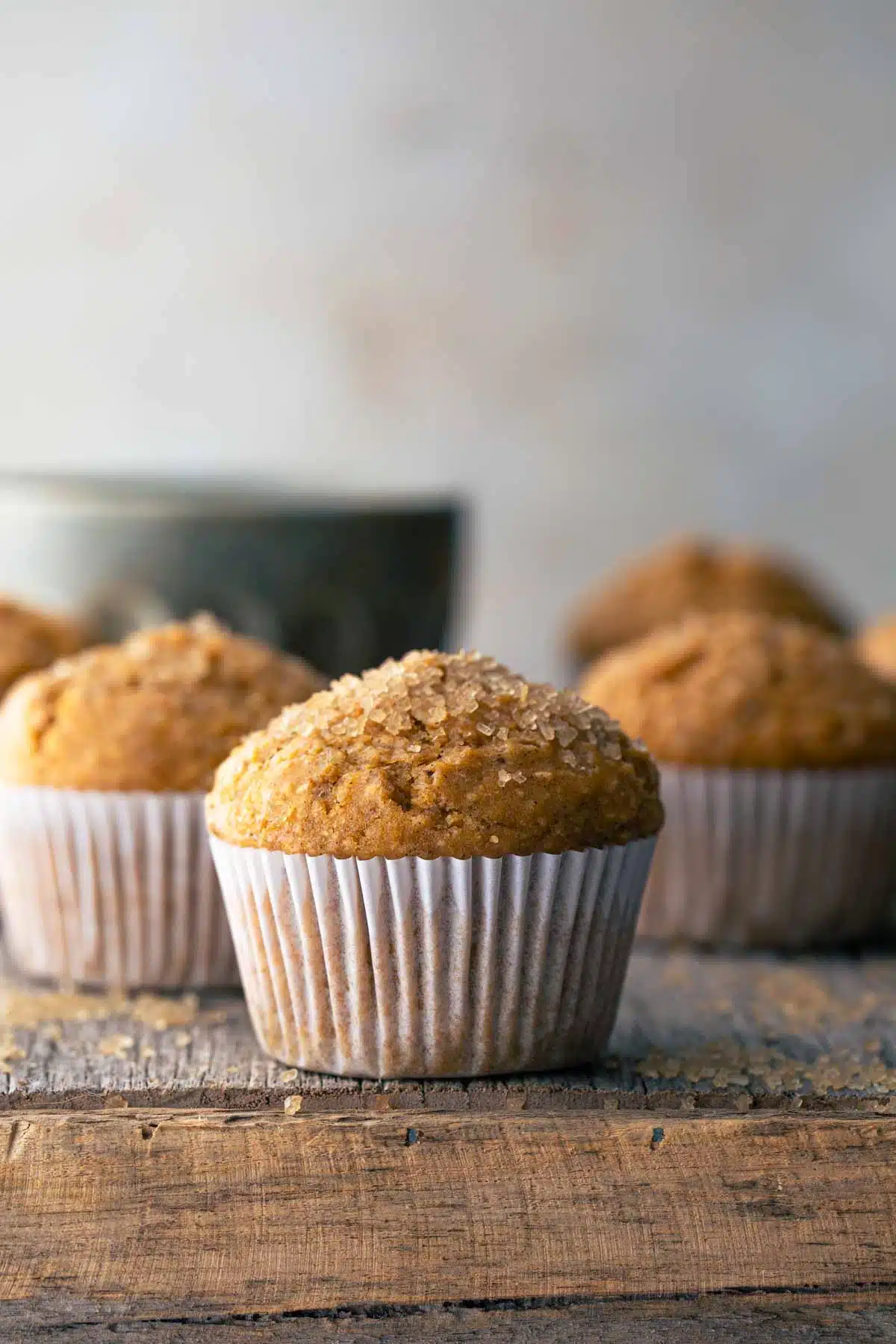 Wholemeal pumpkin muffins on wooden board. 