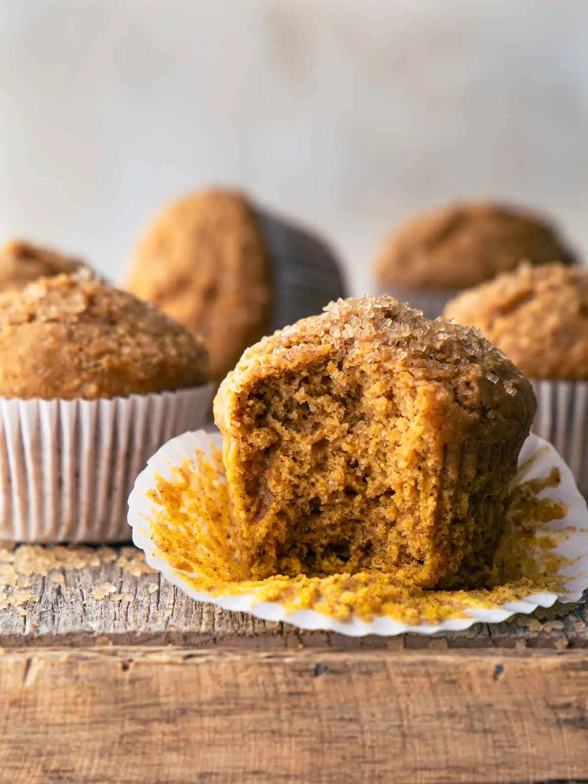 A wholemeal pumpkin muffin with a bite taken out.