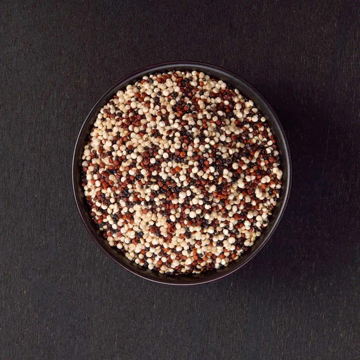 A small bowl of tri-coloured quinoa.