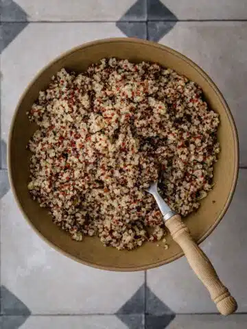 Perfectly cooked quinoa in a bowl with a fork.