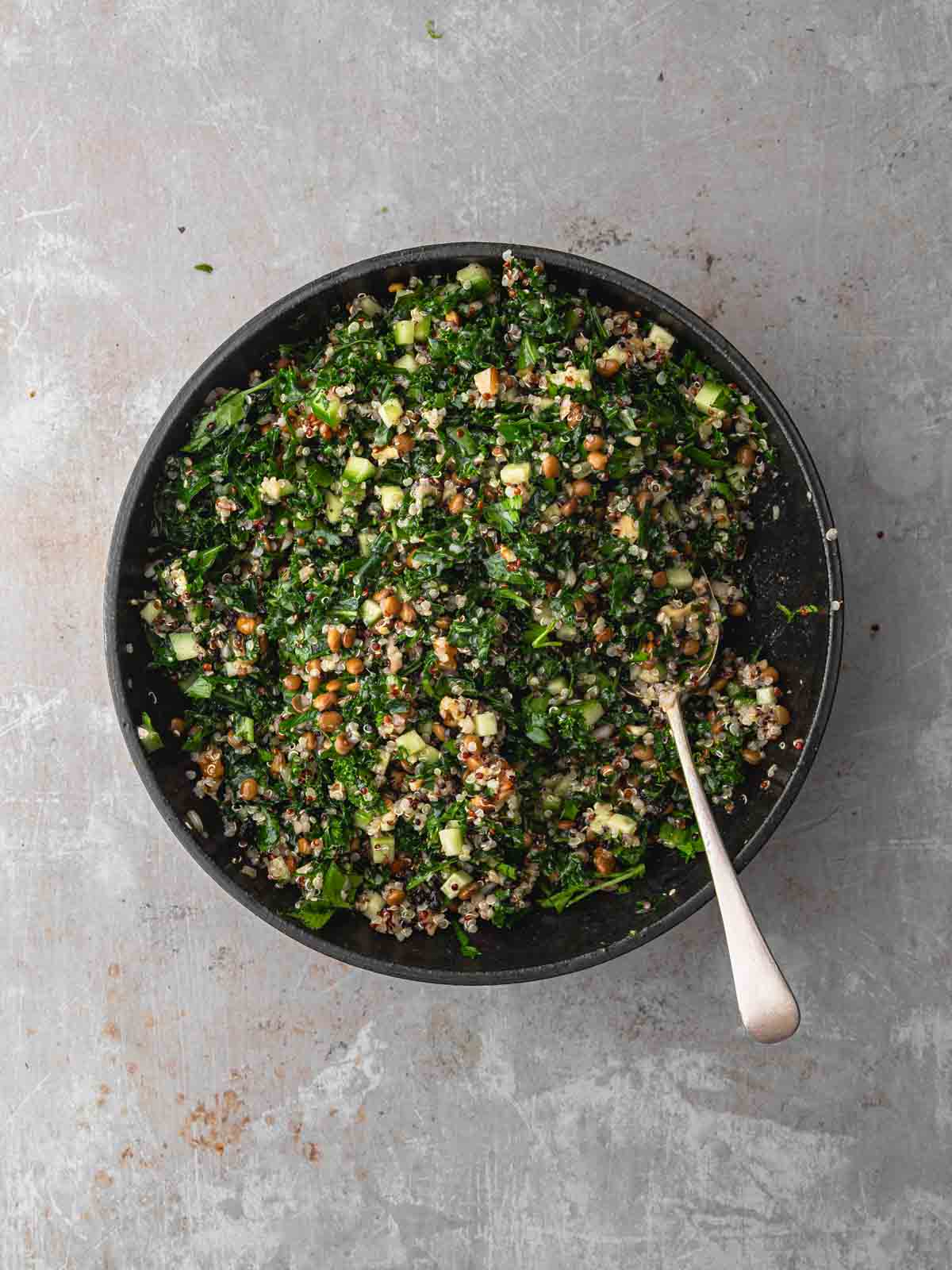 A large bowl of mixed kale and quinoa salad.