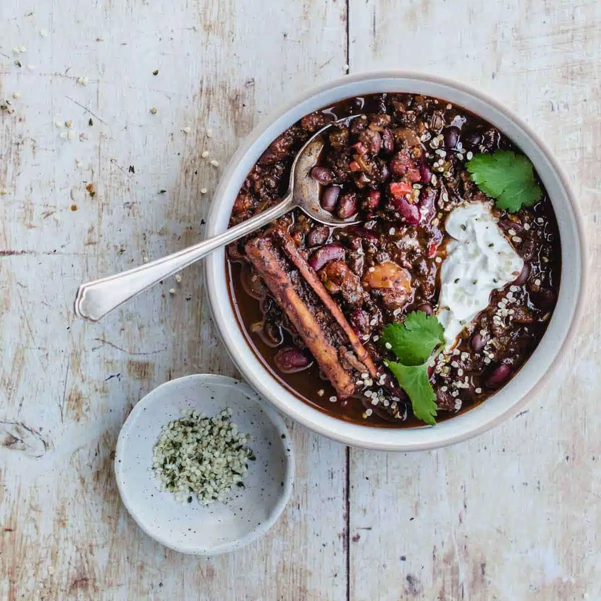 A bowl of chilli with iron-rich beans on a wooden table