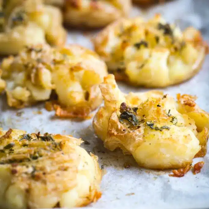 Crispy roast potatoes on a roasting tray.